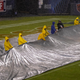 Workers remove a tarp from the turf at Soldier Field before an NFL football game between the Chicago Bears and the San Francisco 49ers Sunday, Sept. 11, 2022, in Chicago.